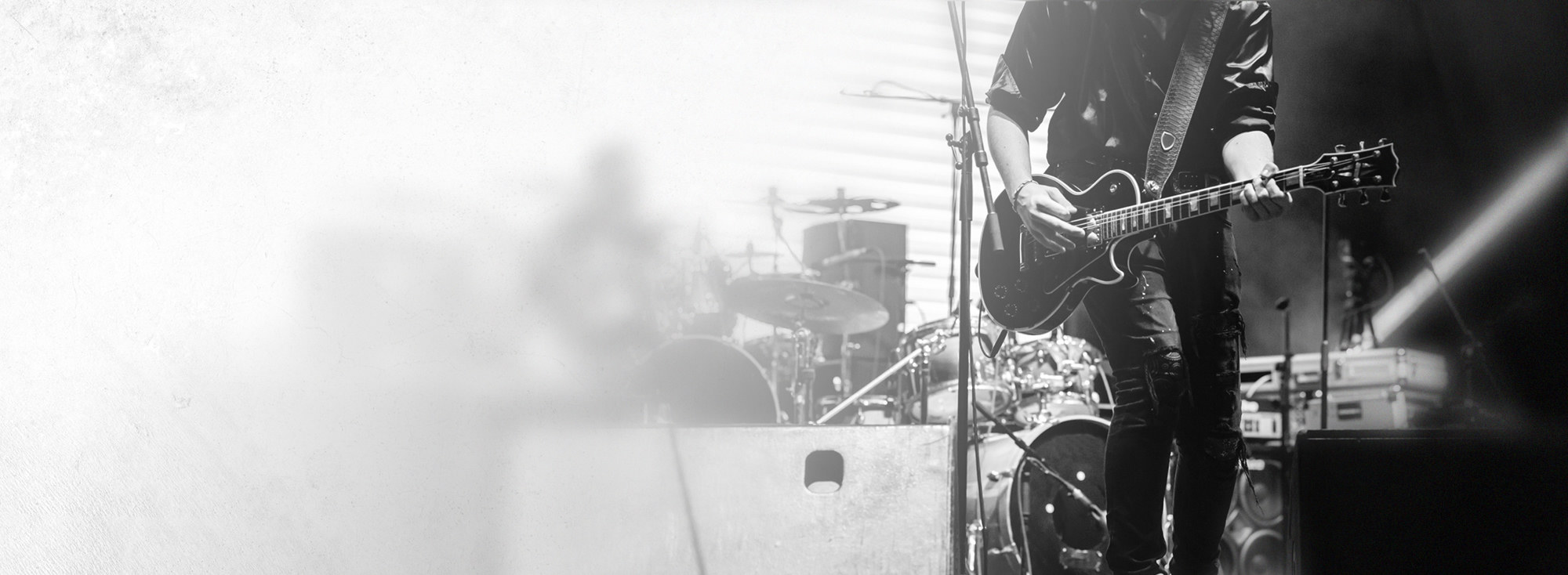 Professional musician with guitar on stage